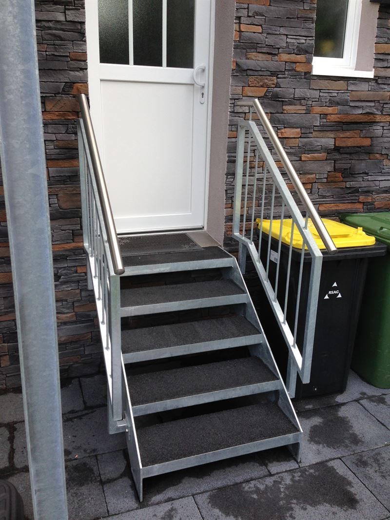 Eine Treppe, die zu einer weißen Tür führt