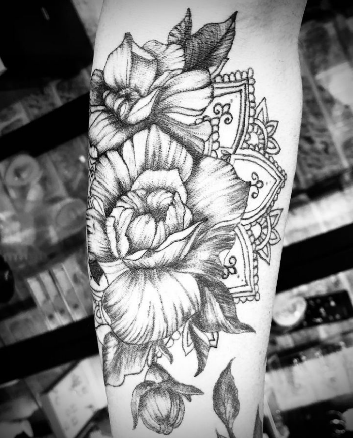 Tatouage avec des fleurs sur un bras