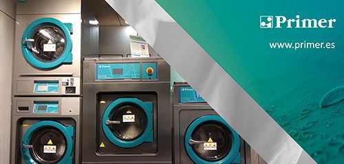 Un montón de lavadoras están apiladas una encima de otra en una lavandería automática.