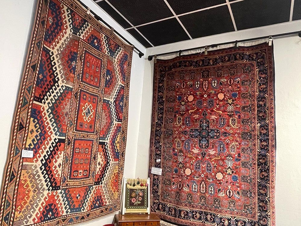 In einem Zimmer hängen zwei Teppiche an der Wand.