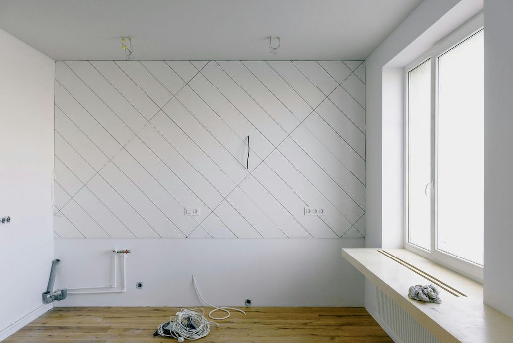 Una habitación vacía con una pared blanca y una ventana.