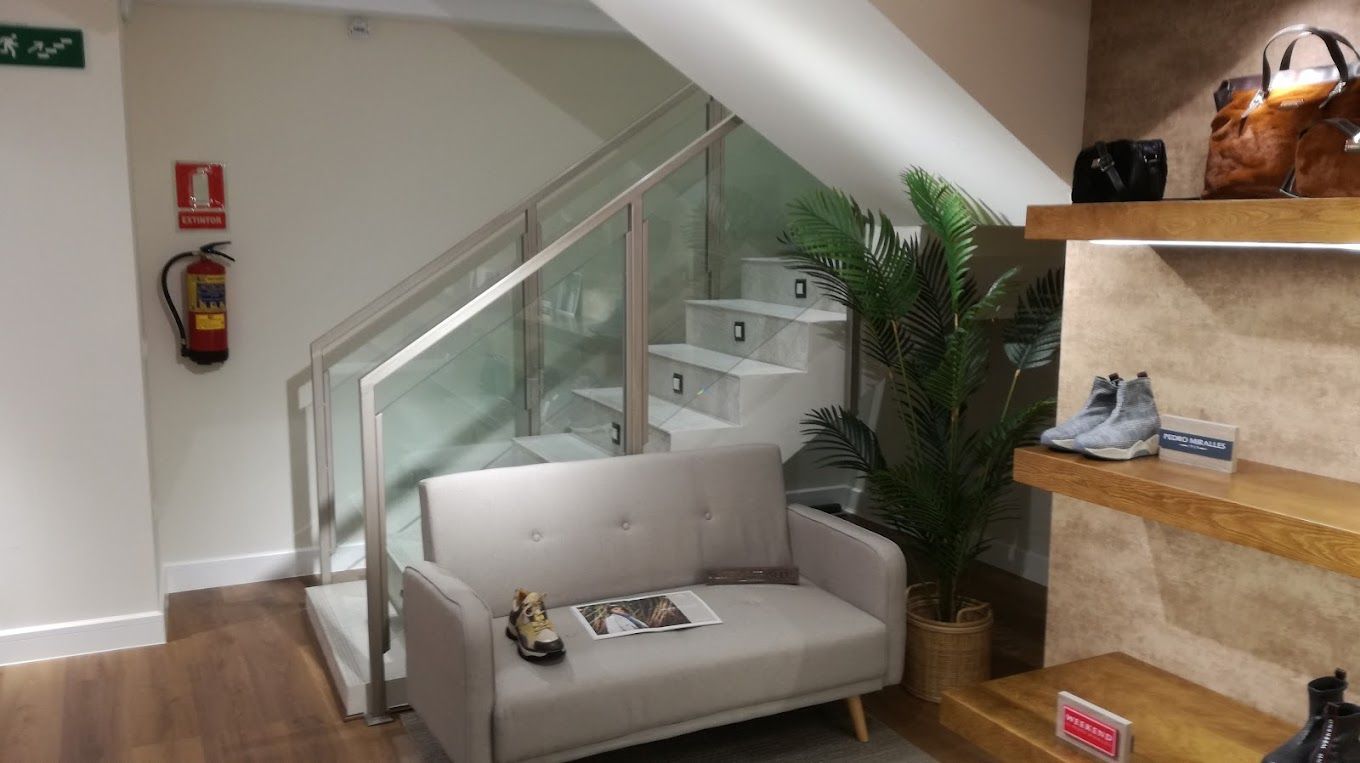 Hay un sofá en el medio de una habitación con escaleras.