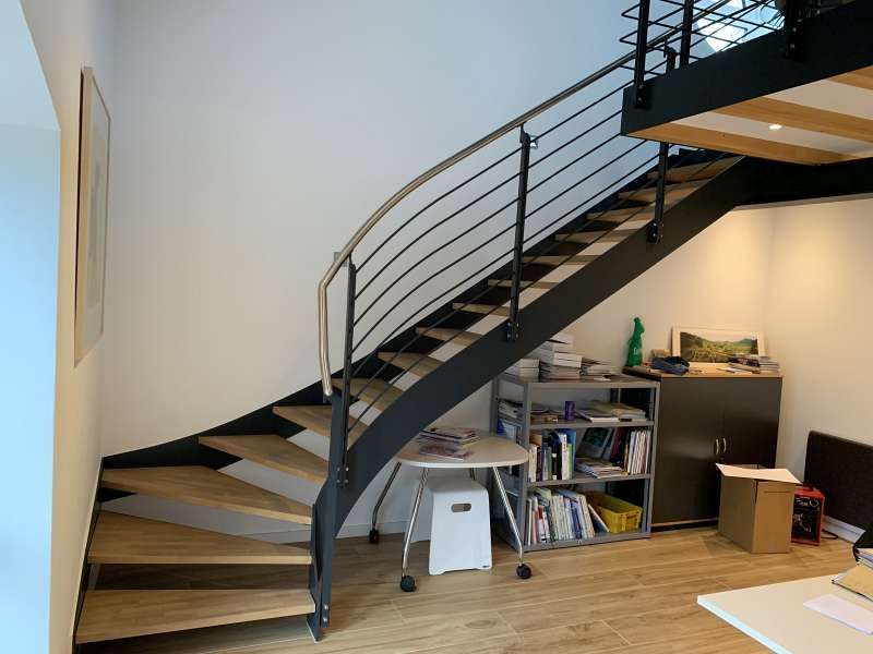 Eine Holztreppe mit einem Metallgeländer in einem Raum