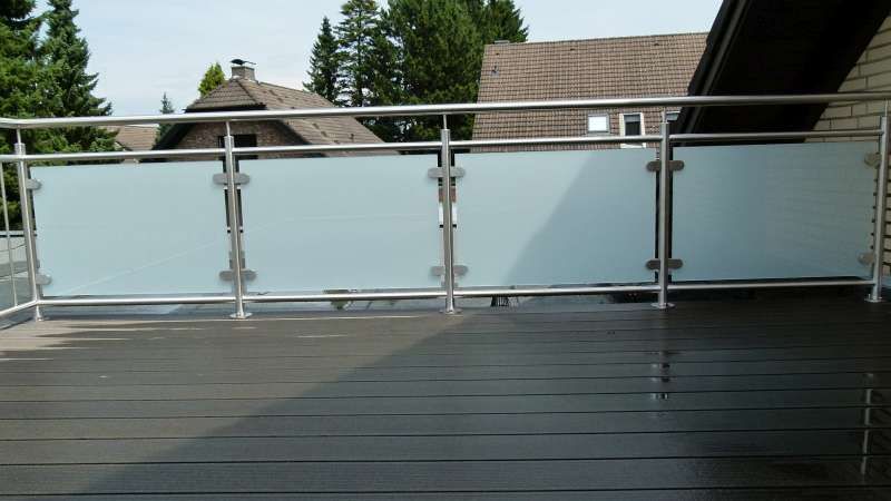Ein Balkon mit Edelstahlgeländer und Milchglas