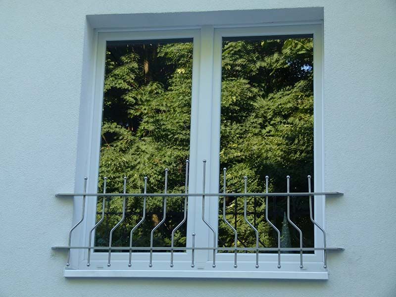 Ein weißes Fenster mit einem Metallgeländer