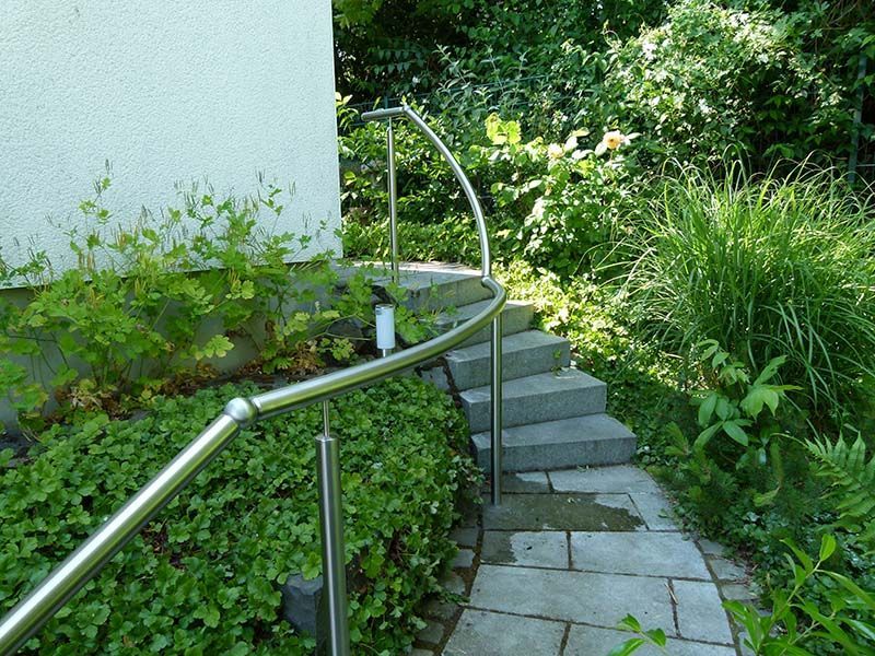 Eine Treppe mit einem Edelstahlgeländer, das hinaufführt