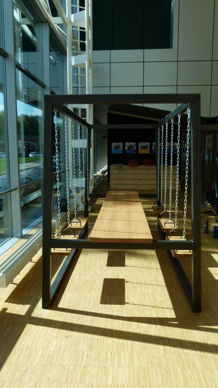 Eine Reihe von Schaukeln in einem Raum mit einem großen Fenster