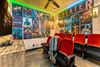 A movie theater with red chairs and posters on the wall.