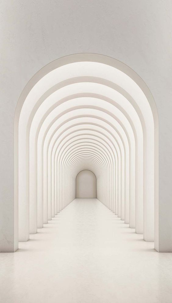 Largo pasillo arqueado de color blanco con columnas que se pierde en la distancia.