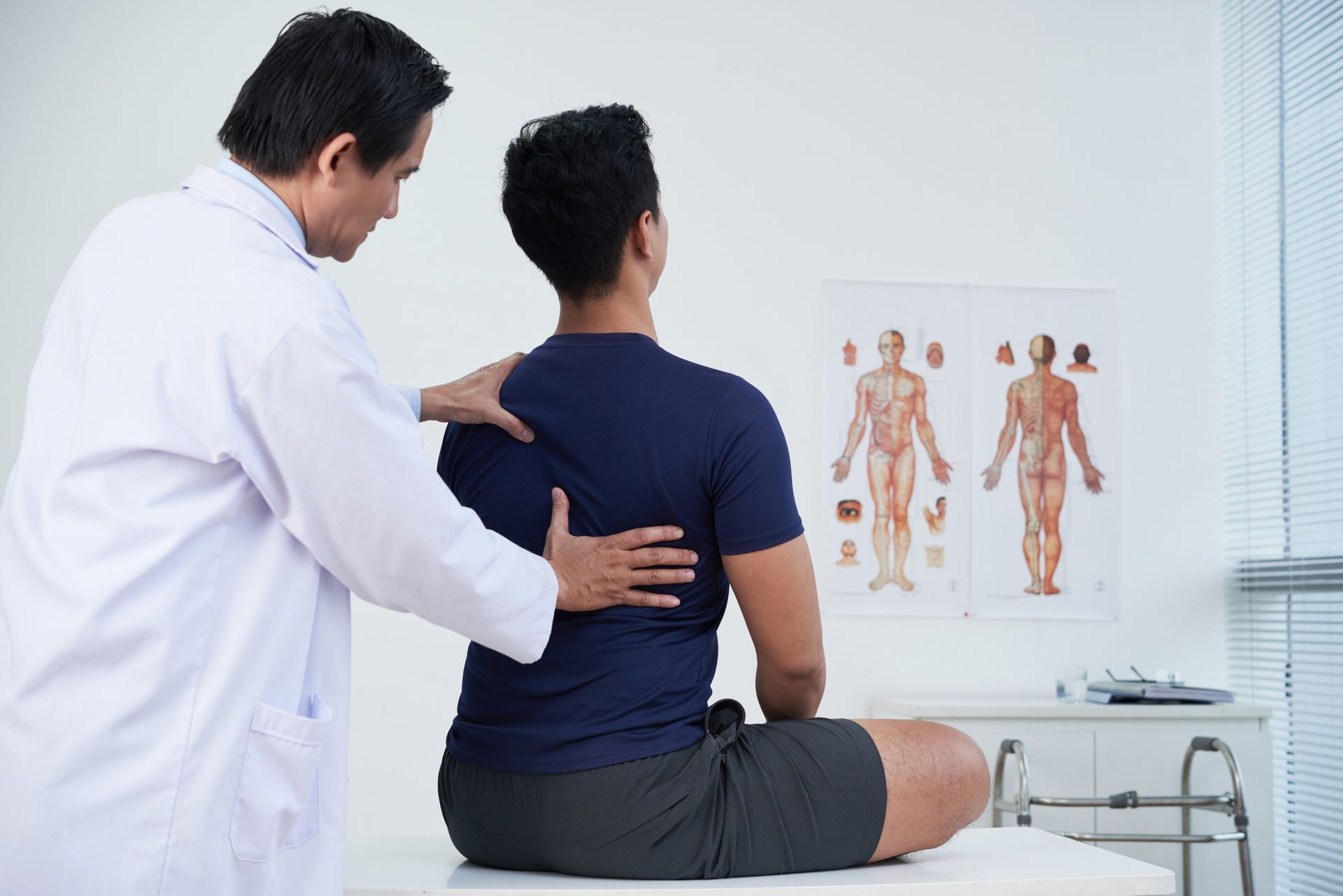 Chiropracteur auscultant le dos d'un homme