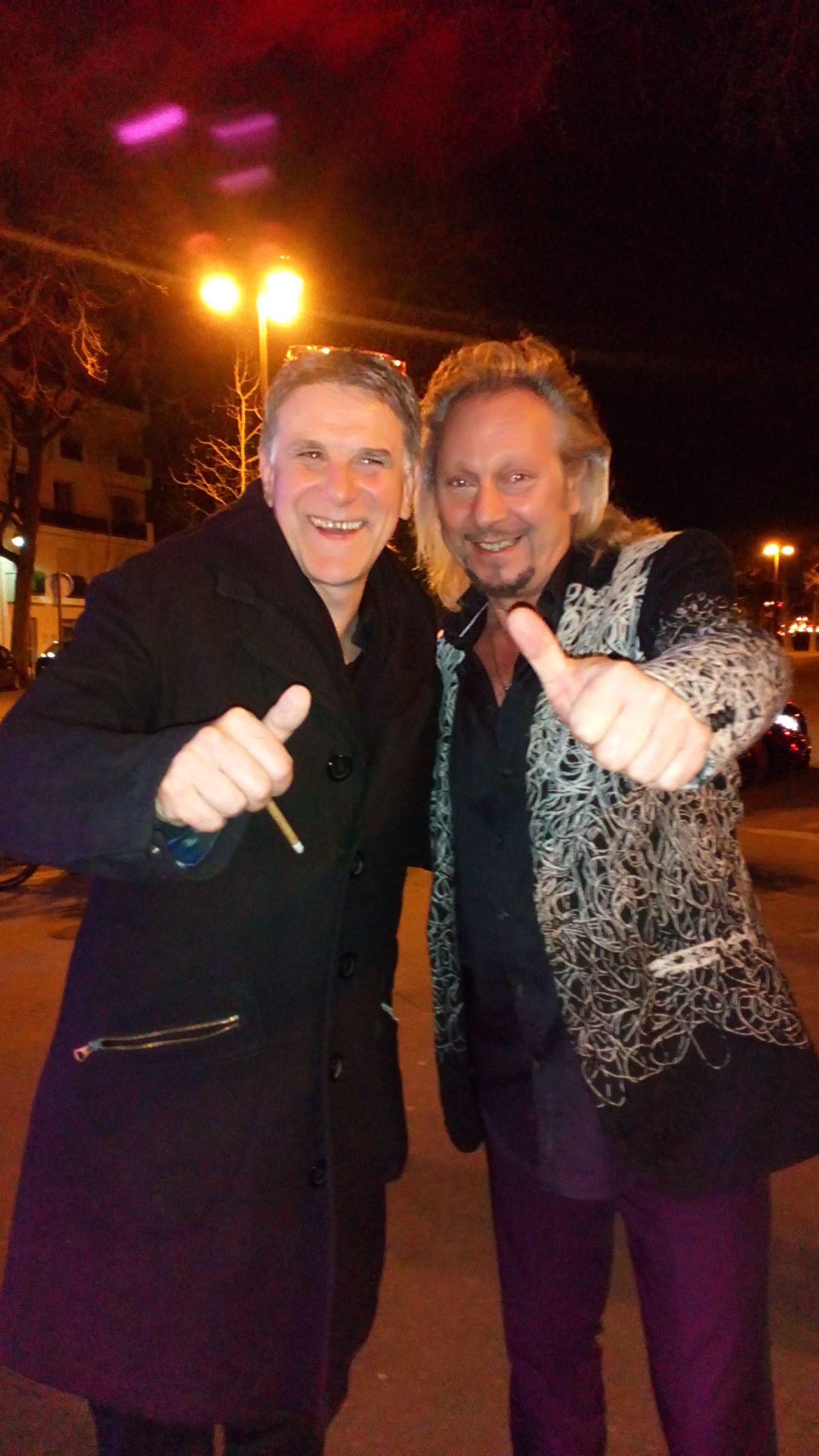 JOHNNY DEMS et Tex, une personnalité de l'audiovisuel, dehors, la nuit.