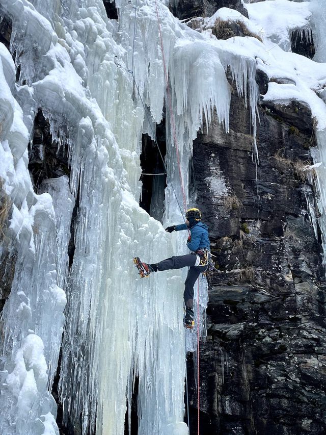Ice climbing a frozen waterfall in Romsdalen