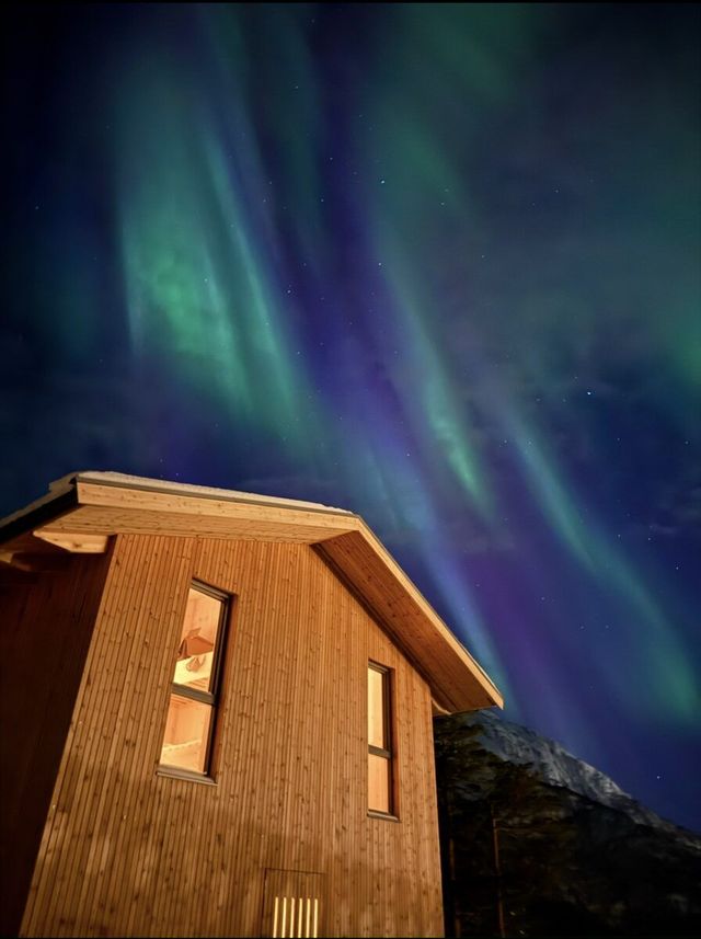 Northern lights over The Crux cabin in Romsdalen