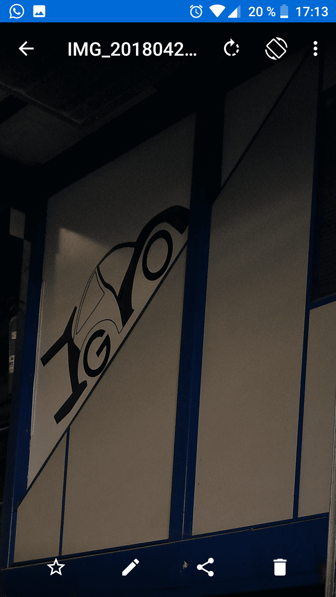 La pantalla de un teléfono muestra una imagen de un edificio con un automóvil encima.