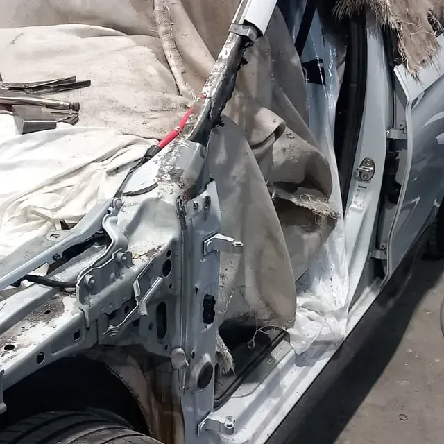 Se está desmantelando un coche con la puerta abierta