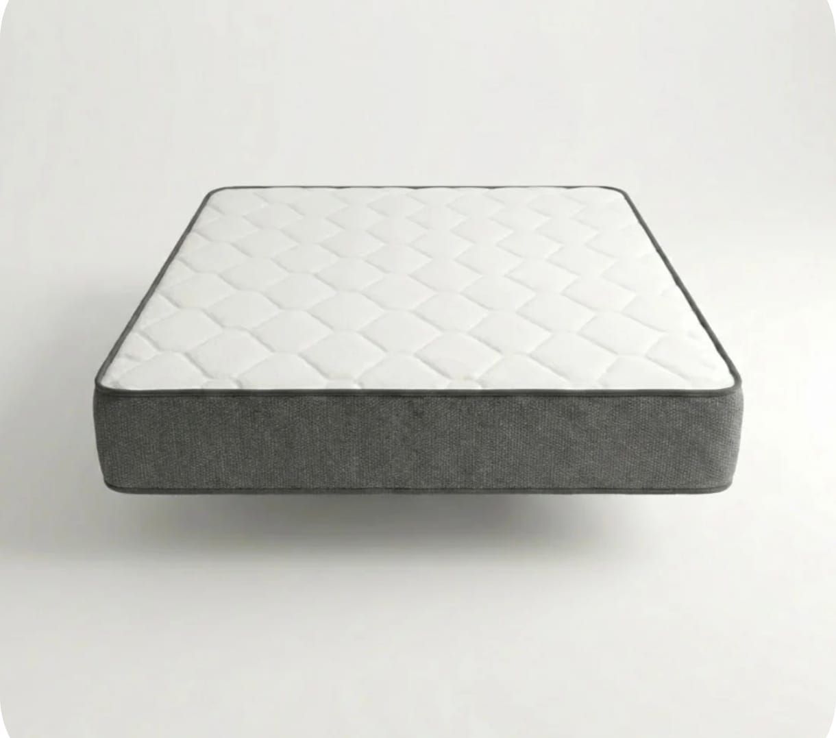 Un colchón con la superficie blanca y los laterales gris oscuro, que parece flotar sobre un fondo blanco liso.