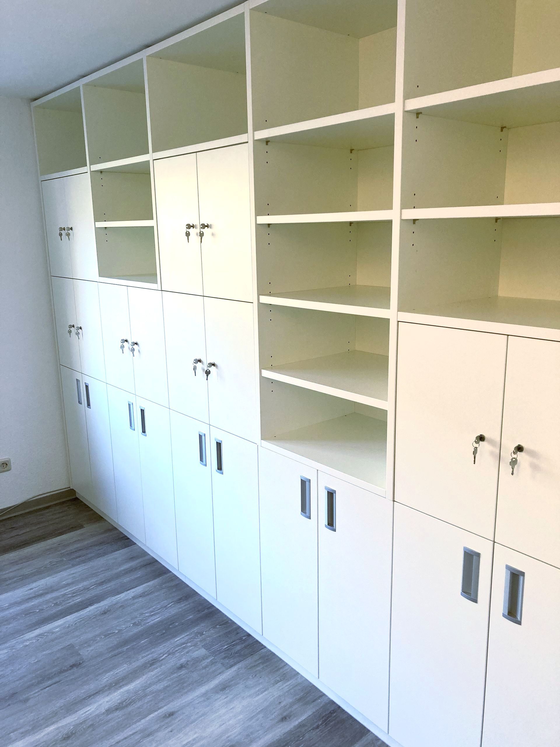 Weiße Schrankwand mit abschließbaren Türen