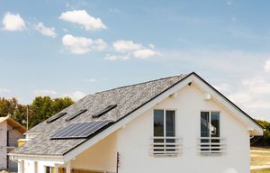 Una casa blanca con paneles solares en el techo