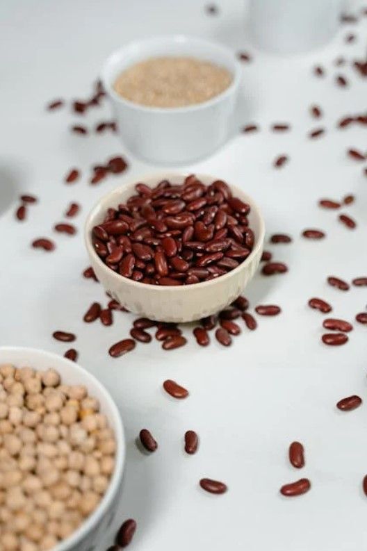 Hay muchos tipos diferentes de frijoles en tazones sobre la mesa.