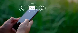 Una persona sostiene un teléfono celular con íconos de contacto.