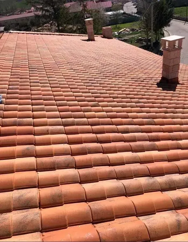 Un tejado con muchas tejas y chimeneas.