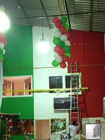 Ein Haufen Luftballons hängt von der Decke eines Gebäudes.