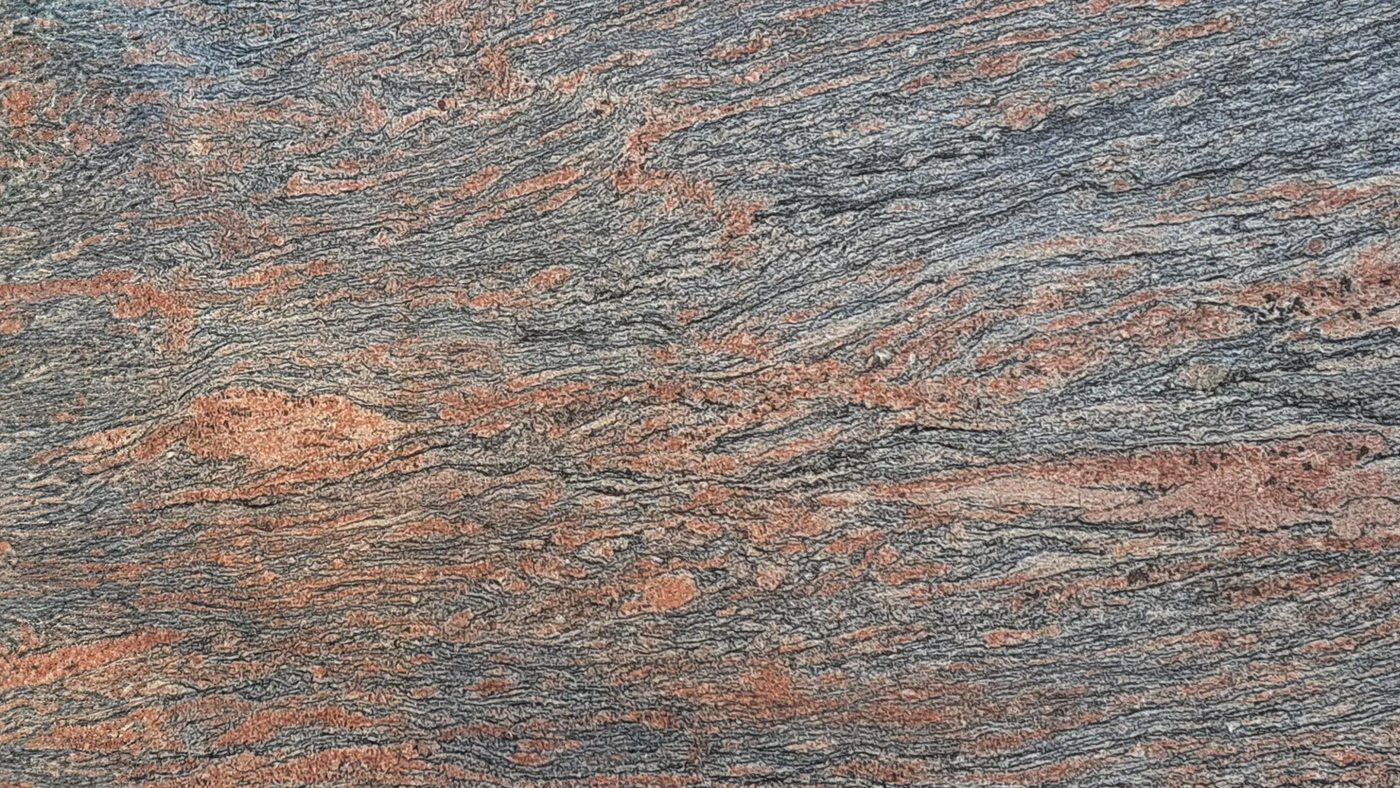 Pierre de granit aux motifs ondulés de couleur grise, orange et noire. granit new sagittarus, granit brezil