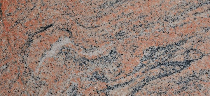 Pierre de granit orange aux motifs ondulés. granit juparana, granit juparana red, granit arrancion 