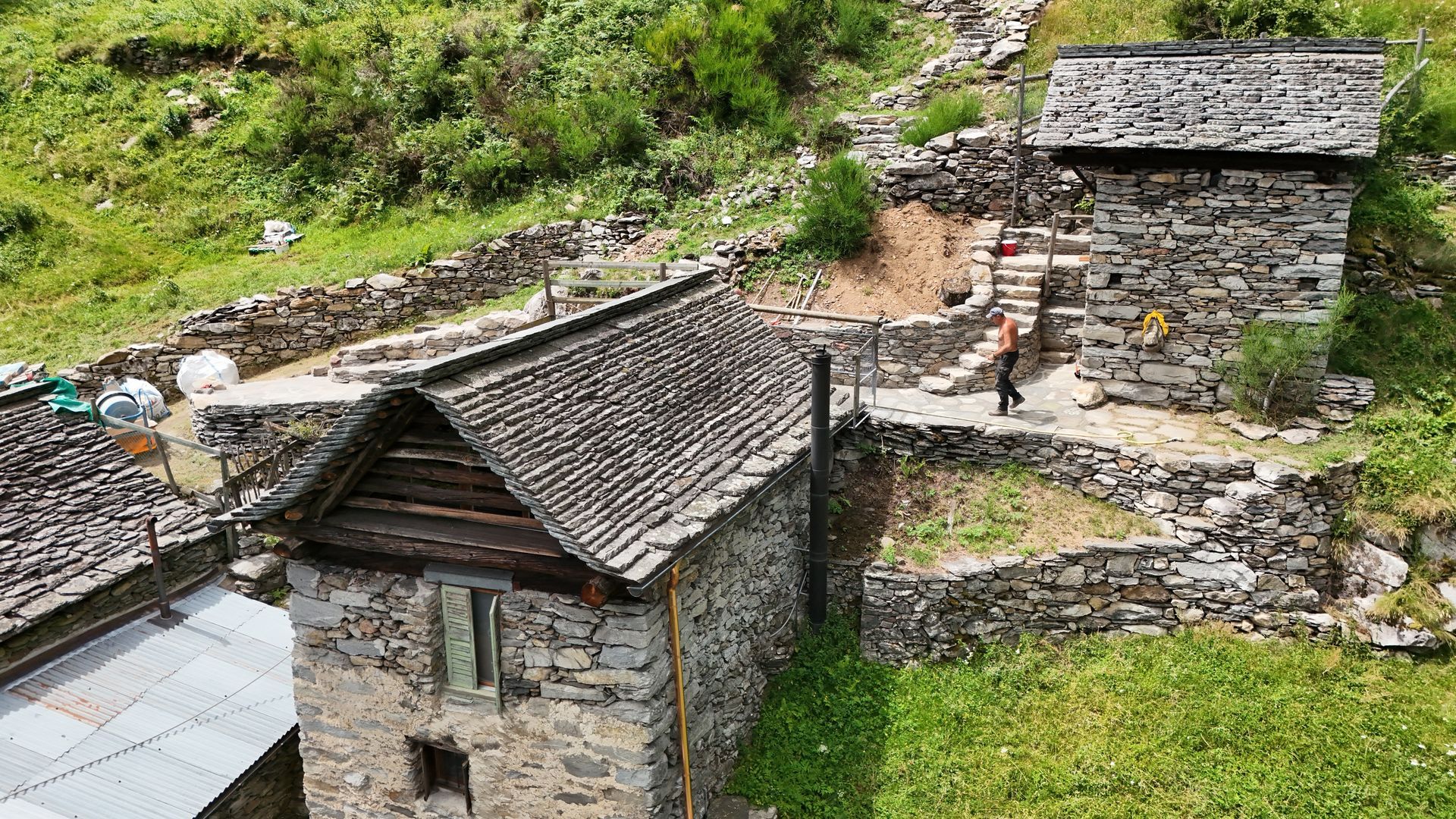 Un sentiero erboso delimitato da un muro di pietra.
