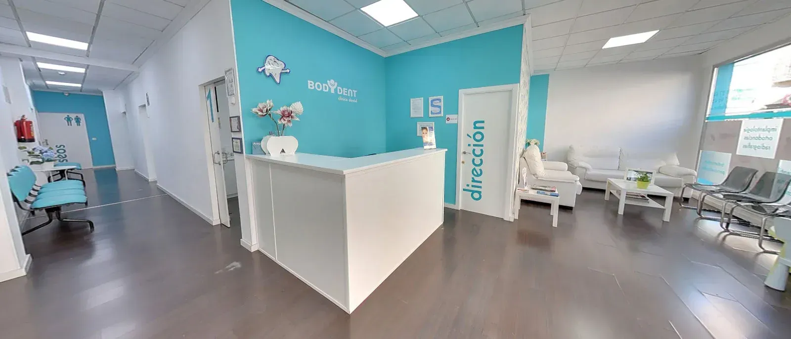 Hay un mostrador de recepción en el medio de la habitación.