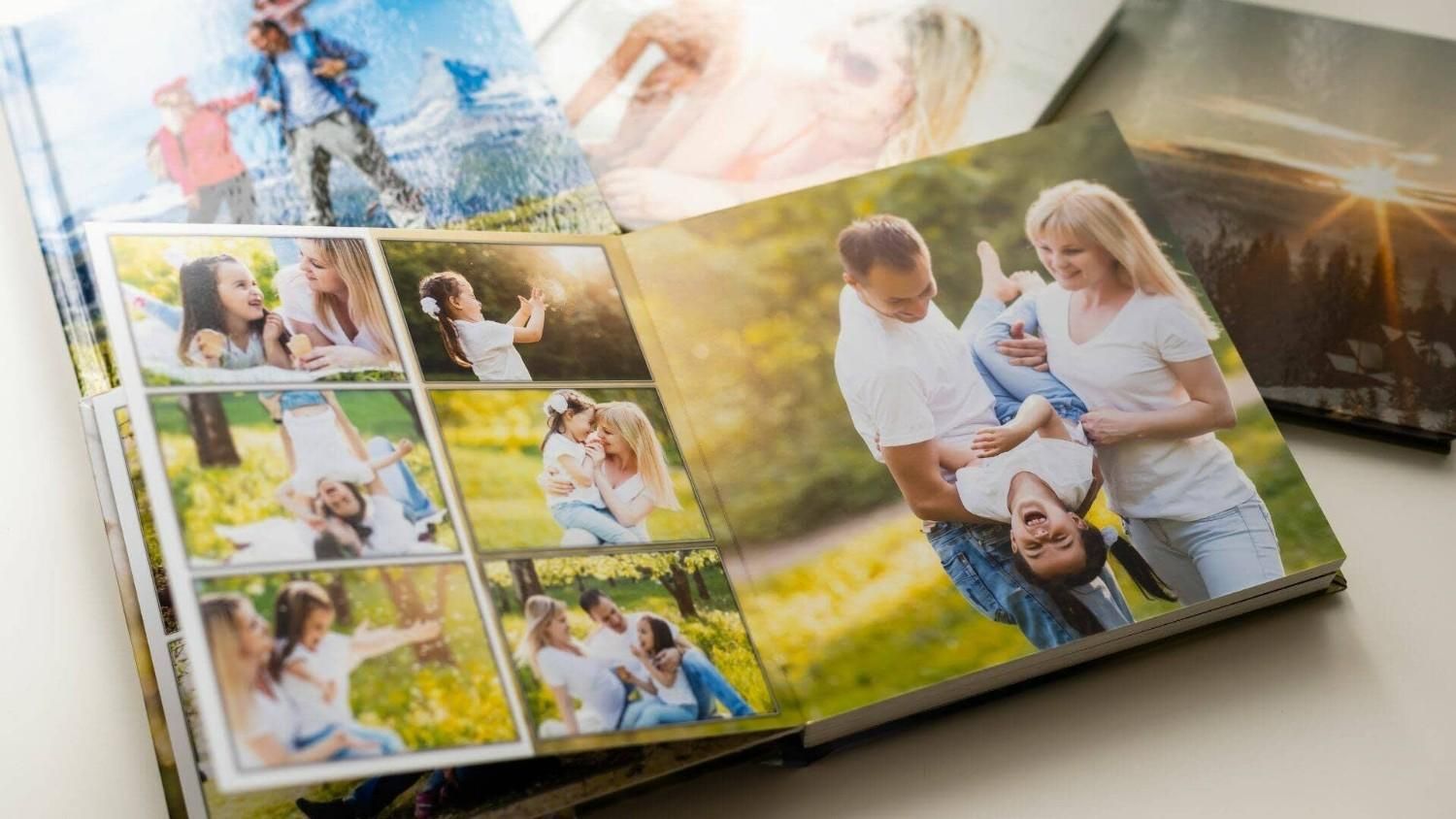 Ábrete un álbum de fotos con coloridas imágenes familiares y escenas al aire libre sobre una mesa.