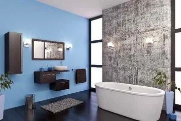 Modernes Badezimmer mit blauen Wänden, Beton-Akzentwand, weißer Badewanne und schwebenden Schränken aus dunklem Holz.