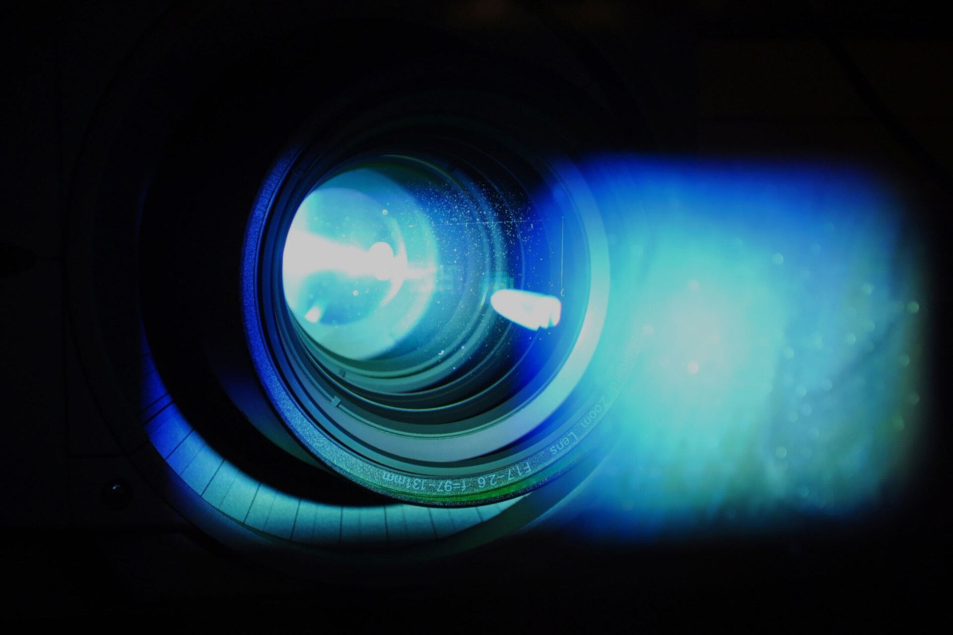 Un primer plano de la lente de una cámara con una luz azul saliendo de ella.