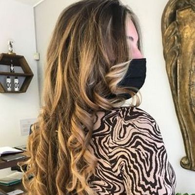 Una mujer que lleva una máscara y una camiseta con estampado de cebra está parada en una habitación.