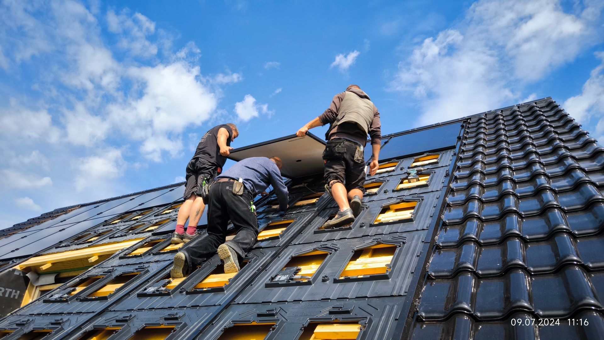 Eine Gruppe Männer arbeitet auf dem Dach eines Gebäudes.