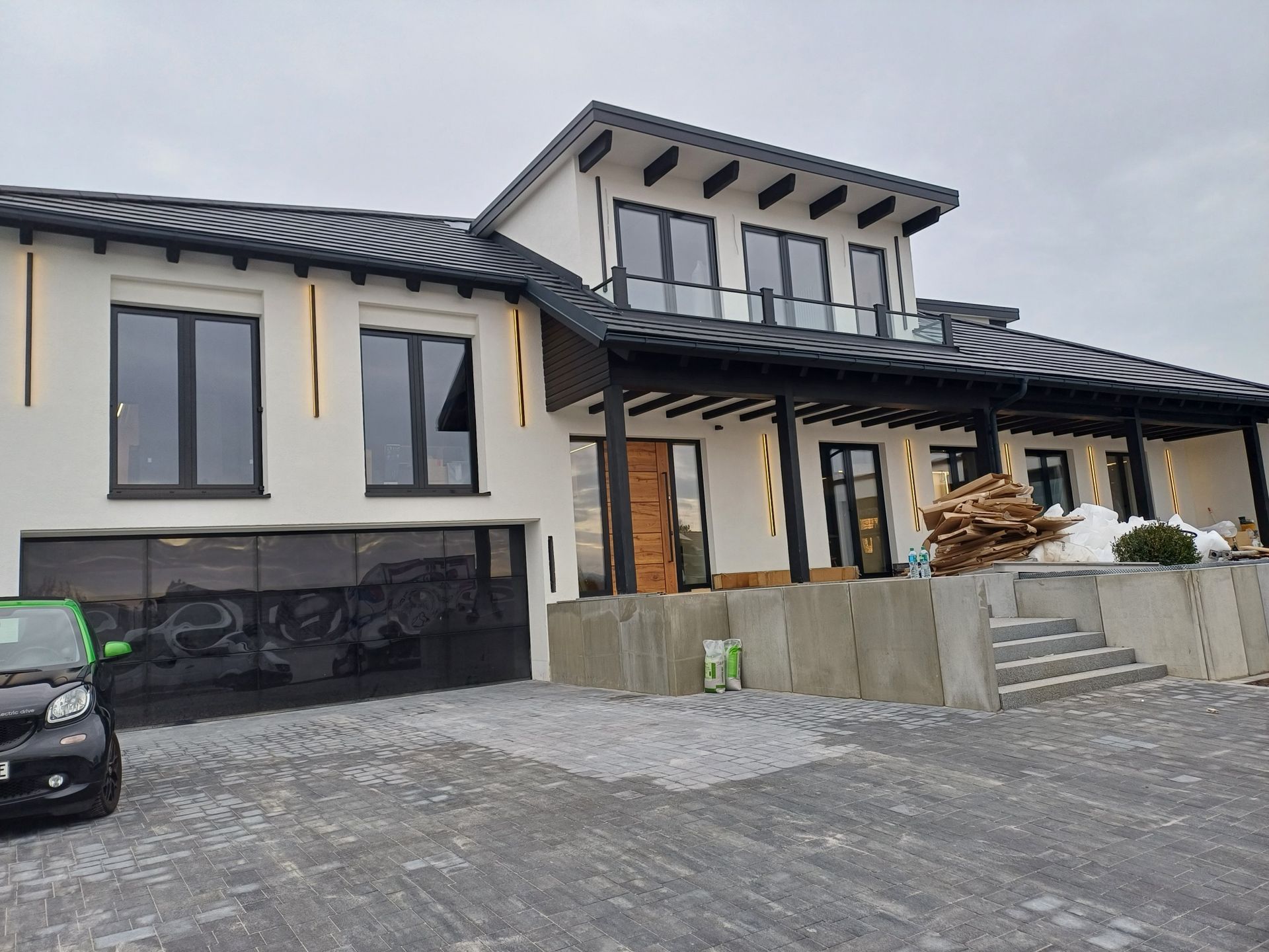 Ein großes weißes Haus mit einem davor geparkten Auto.