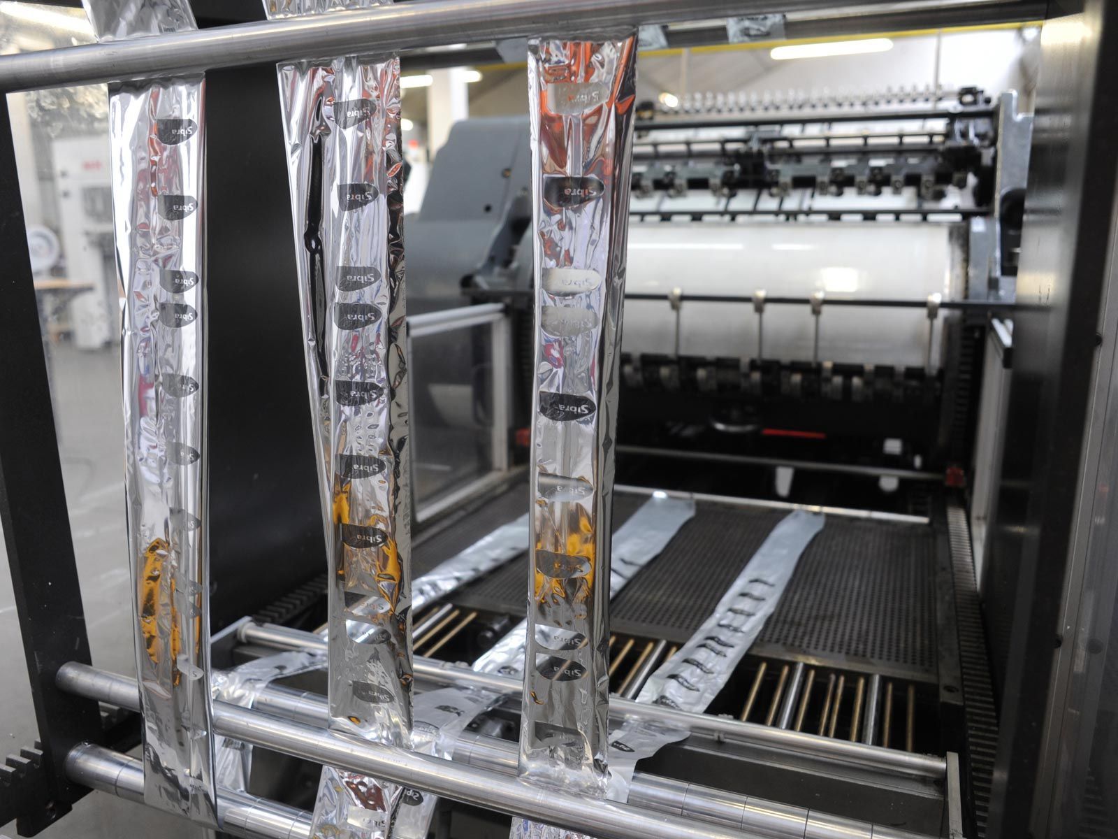 Sachets métalliques sur une machine pour le gaufrage à chaud.