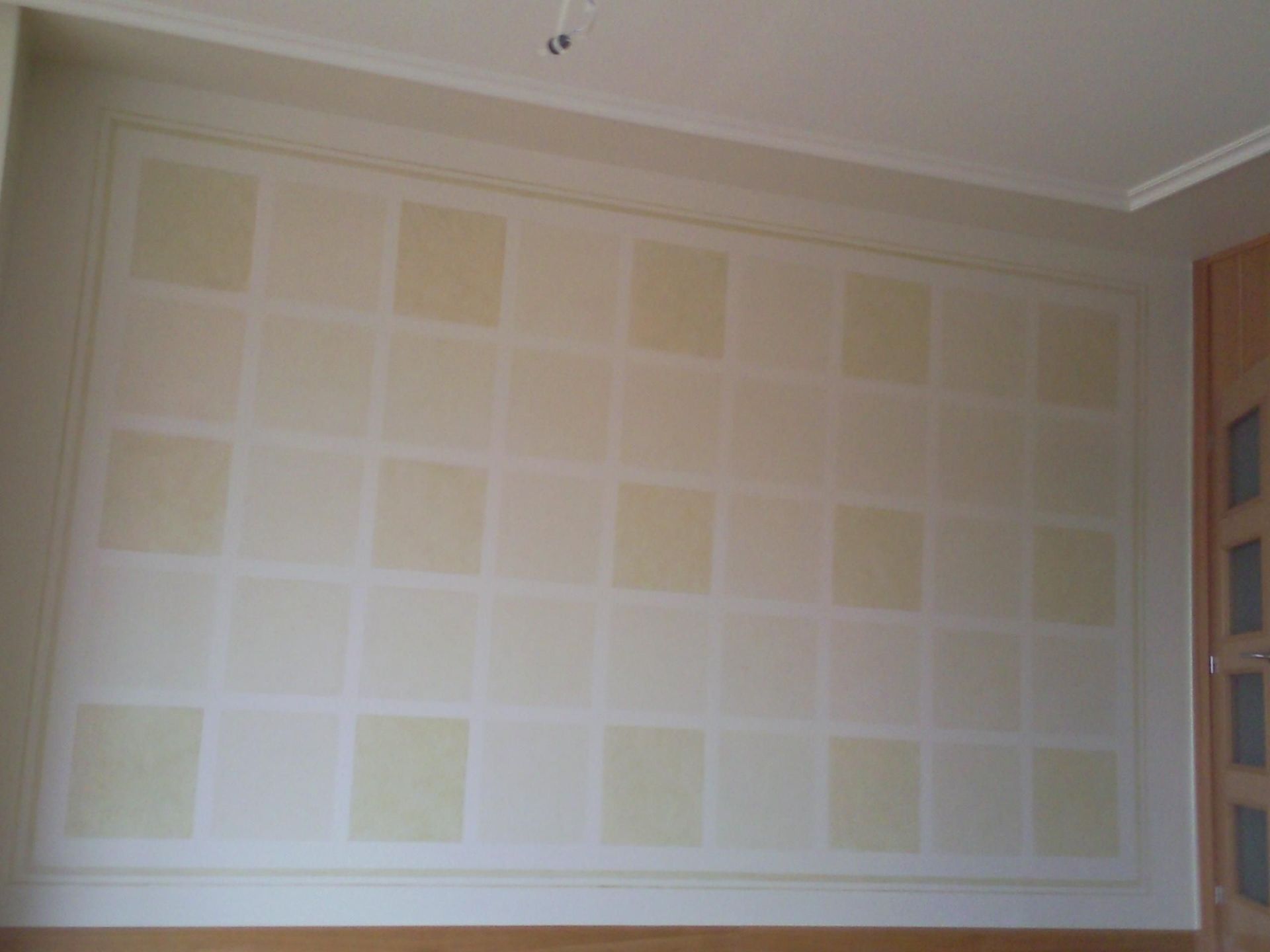 Una pared con un patrón de cuadrados en una habitación.