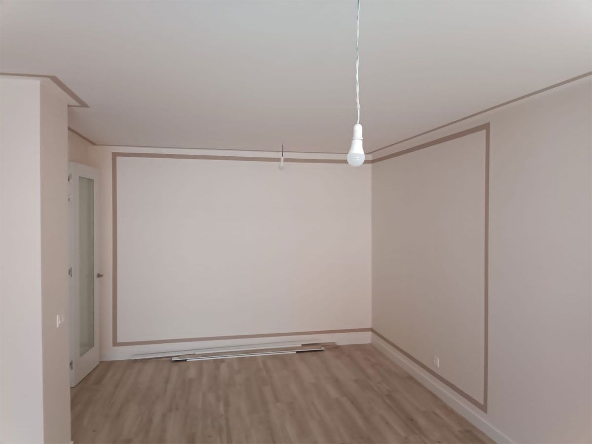 Una habitación vacía con una luz colgando del techo.