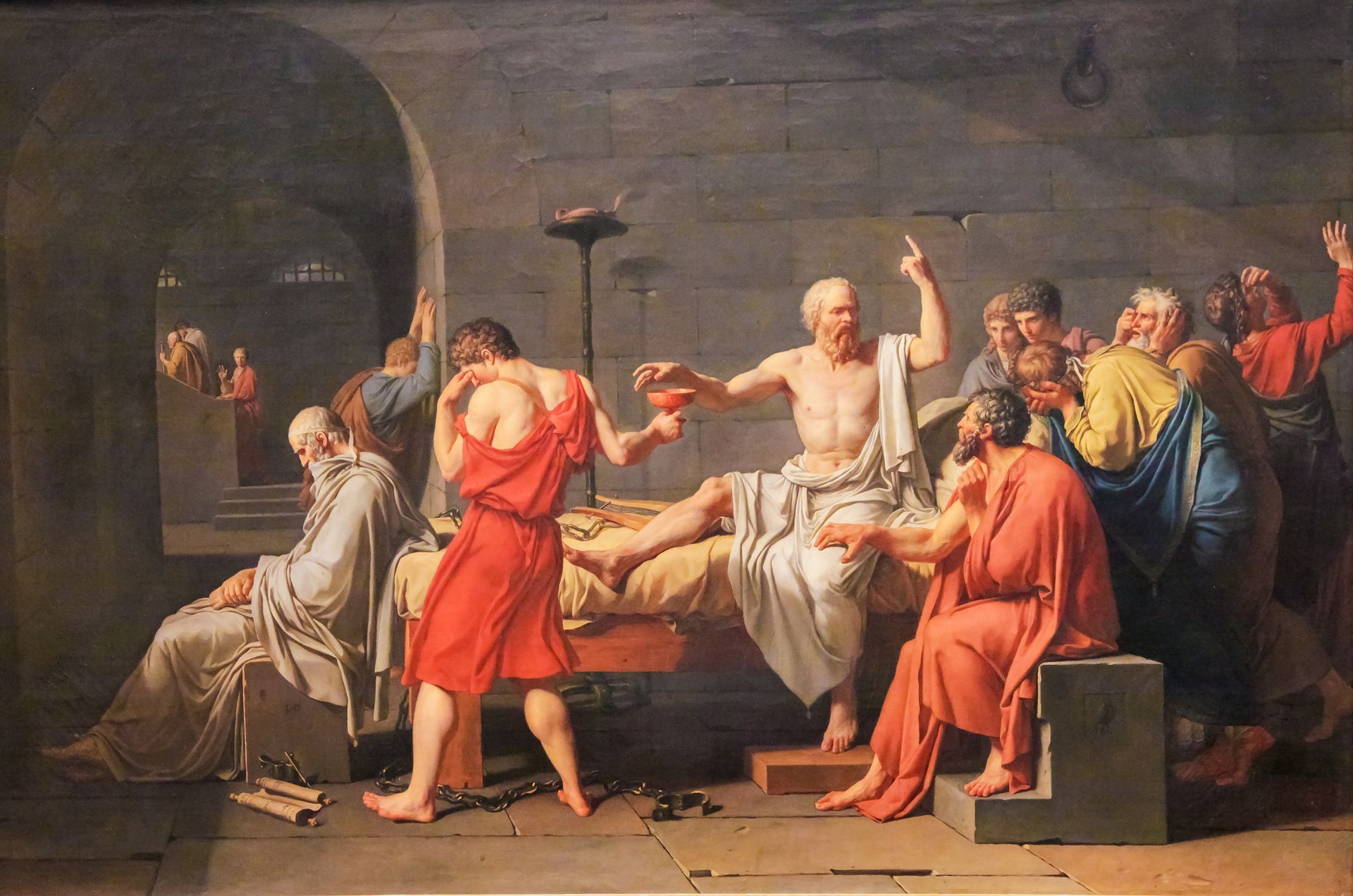 Peinture d'une scène de vie représentant des personnages autour d'un homme allongé dans un espace obscur, l'un d'eux tenant une torche