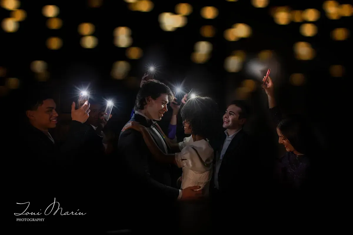 Un hombre con un esmoquin está de pie junto a una mujer con un vestido blanco.