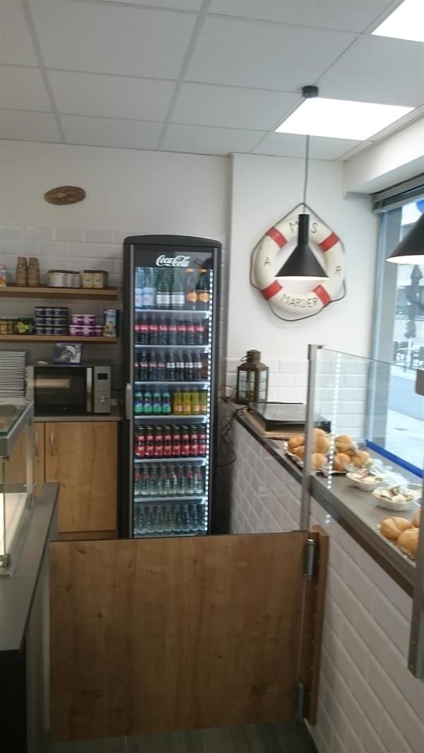 Ein Restaurant mit einem Kühlschrank und einem Rettungsring an der Wand.