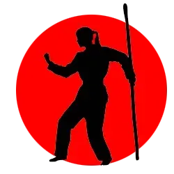 Una silueta de una persona sosteniendo un palo en un círculo rojo.