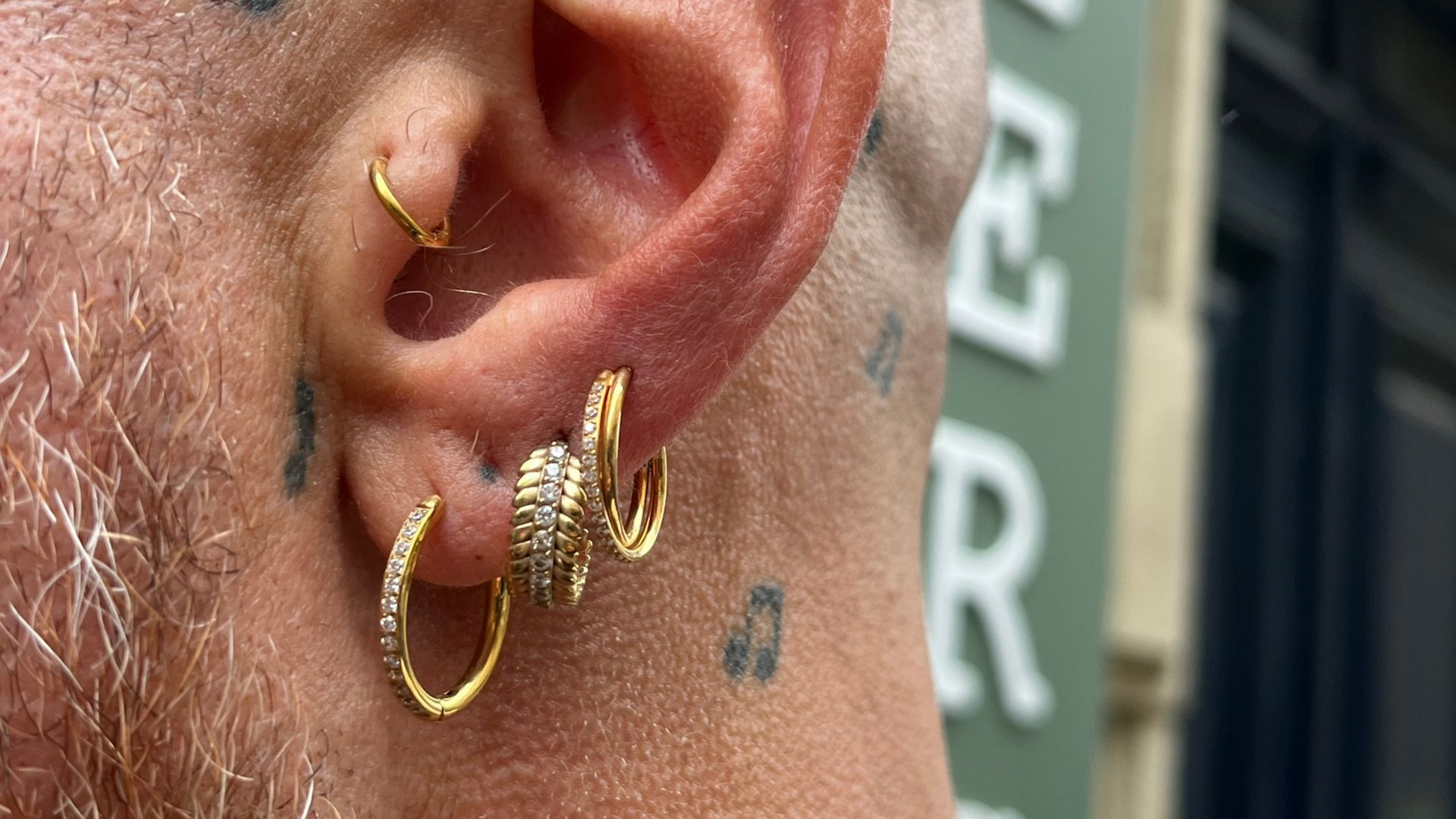 Un homme avec quatre piercings à l'oreille