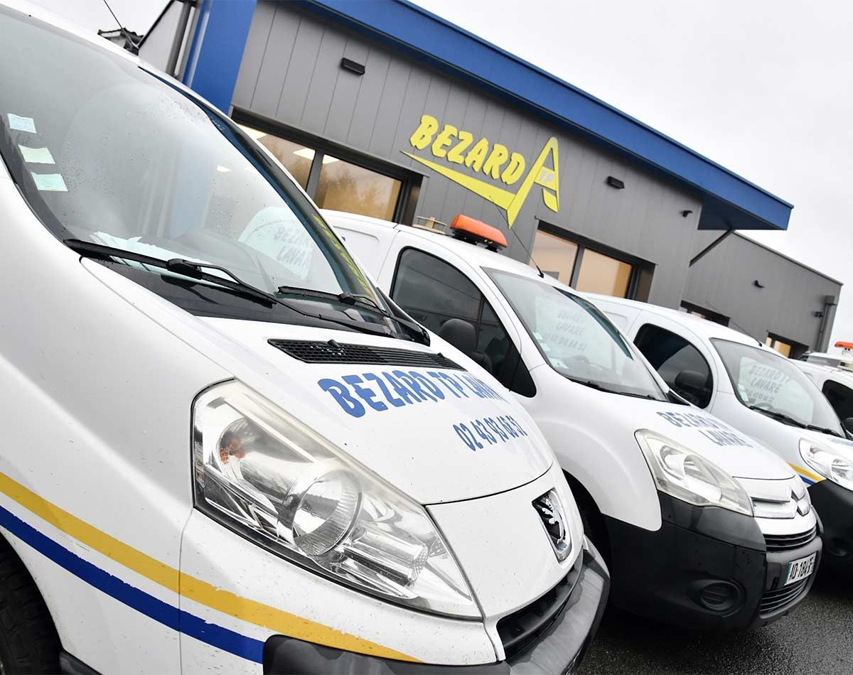 Flotte de véhicules utilitaires de la société Bezard TP garés devant leur entrepôt
