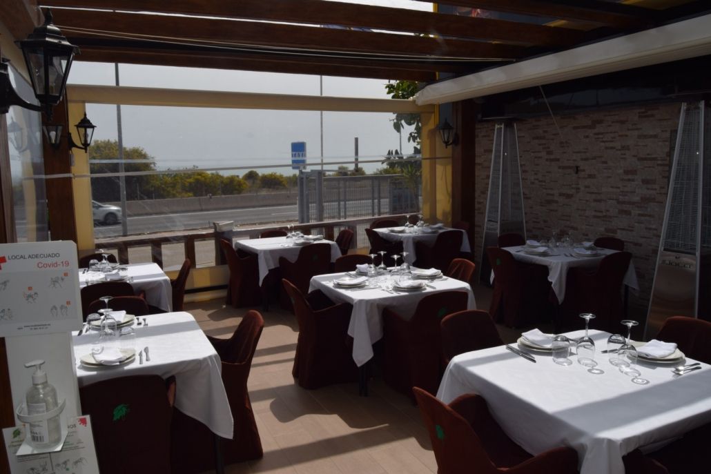 Un restaurante con mesas y sillas y un cartel que dice 'a' en él