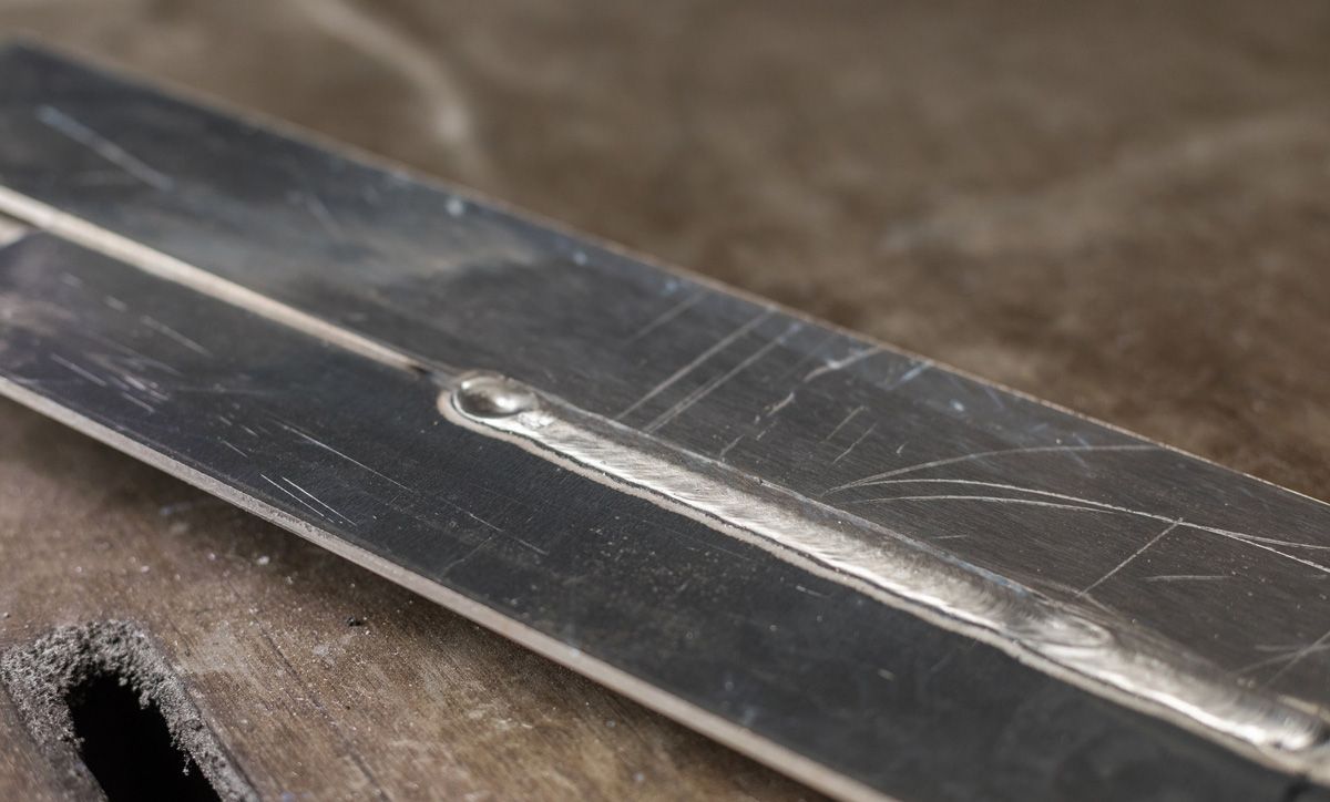 Eine Nahaufnahme eines Metallstücks mit einem Loch darin.