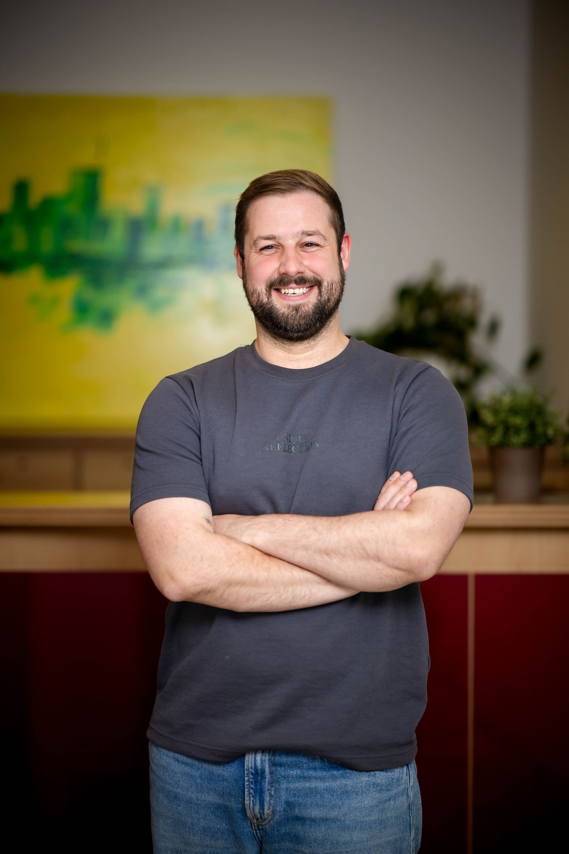 Porträt einer lächelnden Person mit Bart.