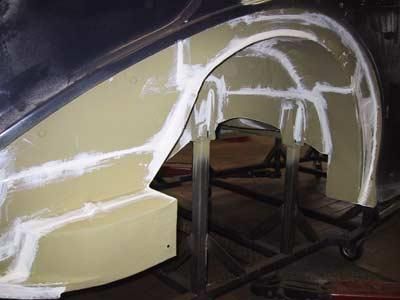 In einer Werkstatt wird ein Kotflügel eines Autos repariert.