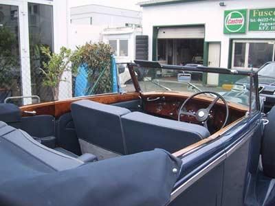 Ein Cabrio steht vor einem Castrol-Schild